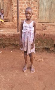image of a smiling and standing little girl