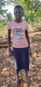 An image of Rose Ndagire standing and smiling