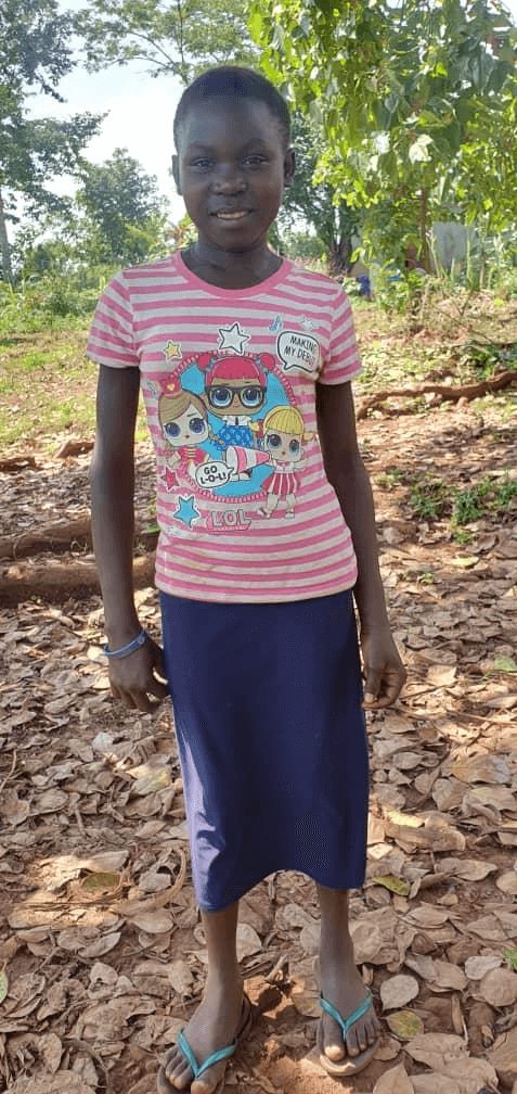An image of Rose Ndagire standing and smiling