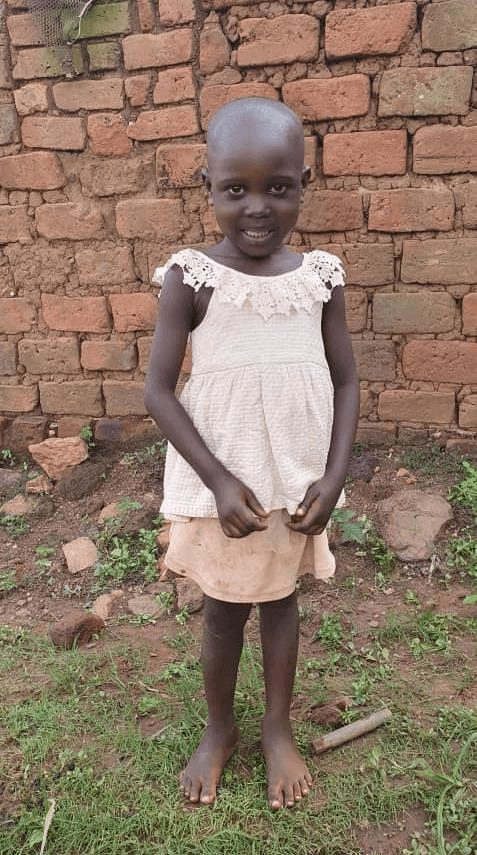 An image of Shalom Nangobi standing and smiling